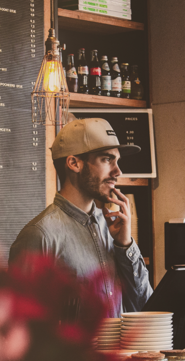 guy-with-cappy-behind-bar